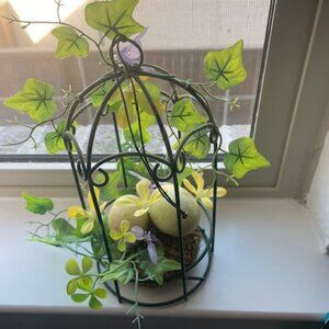 Decorative birdcage floral arrangements with eggs and greenery